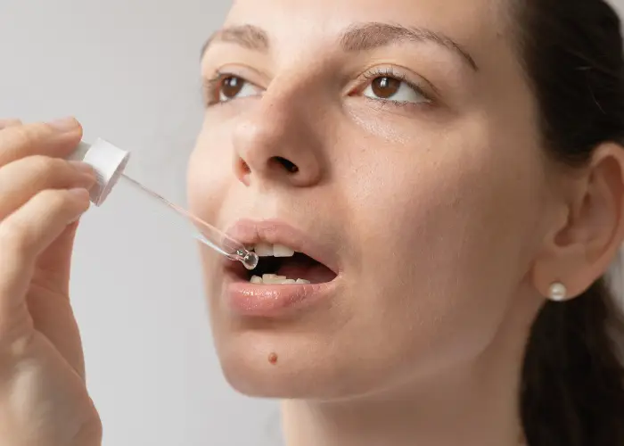 Woman taking a Sublingual Suspension