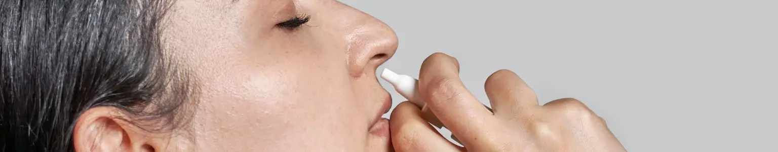Woman using estradiol nasal spray for patulous Eustachian tube